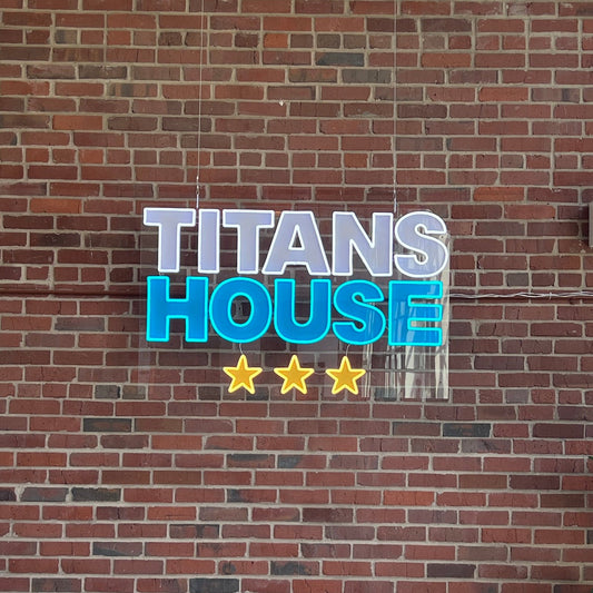 Brick wall with 'Titans House' sign and decorative elements