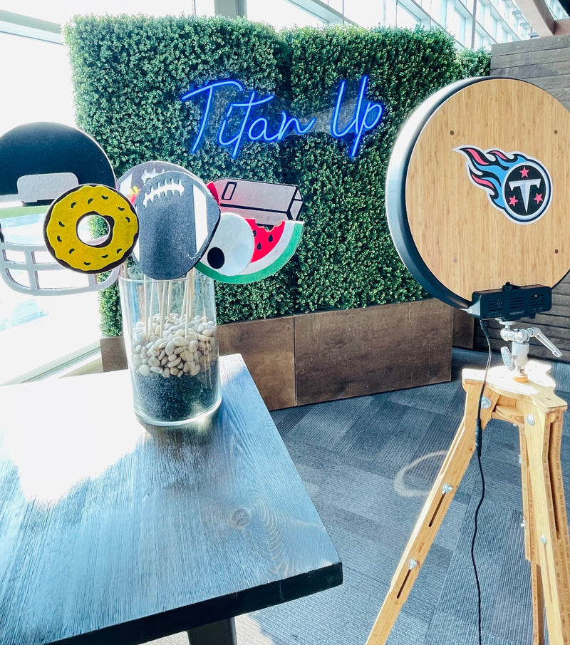 Decorative items on a table with a 'Titan Up' sign in the background