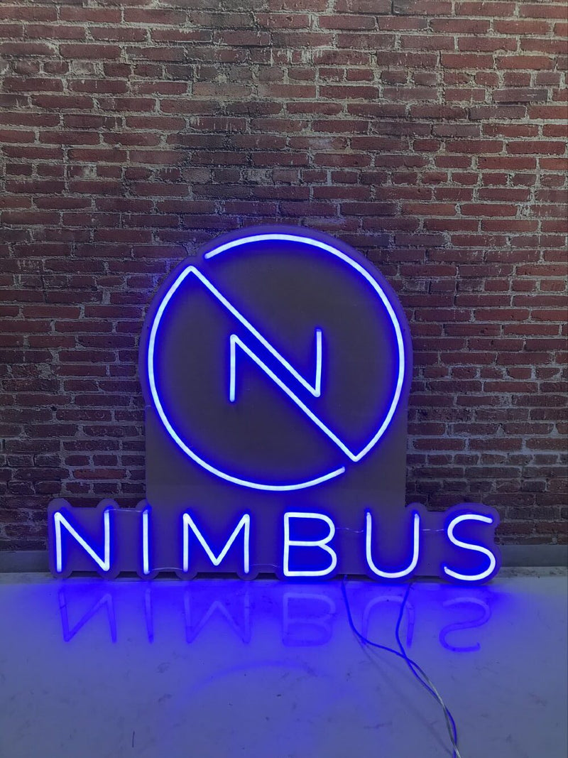 Neon sign with 'Nimbus' logo on a brick wall background